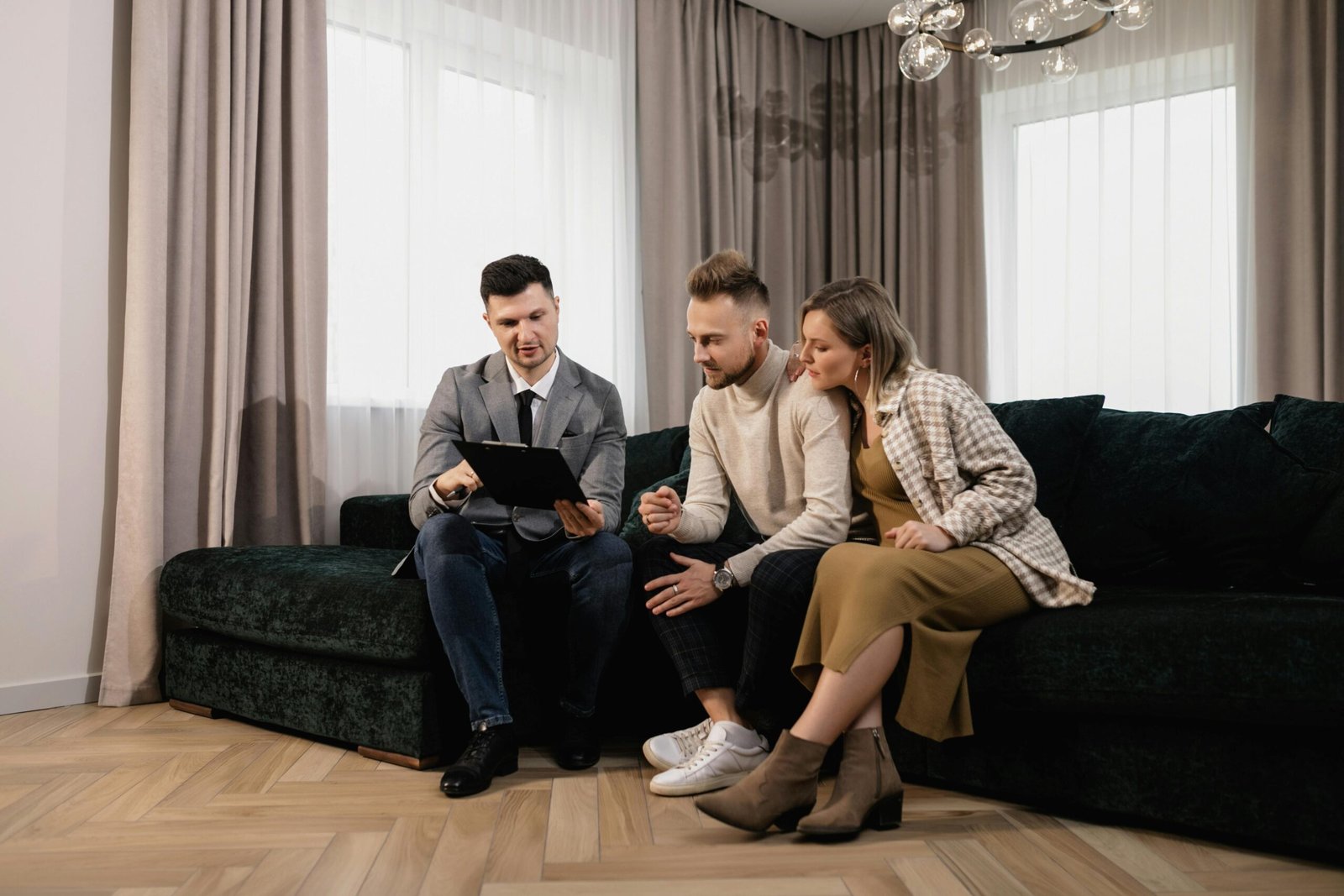 Real estate Listing Agent discussing home-selling strategy with a homeowner, showcasing a property for sale.